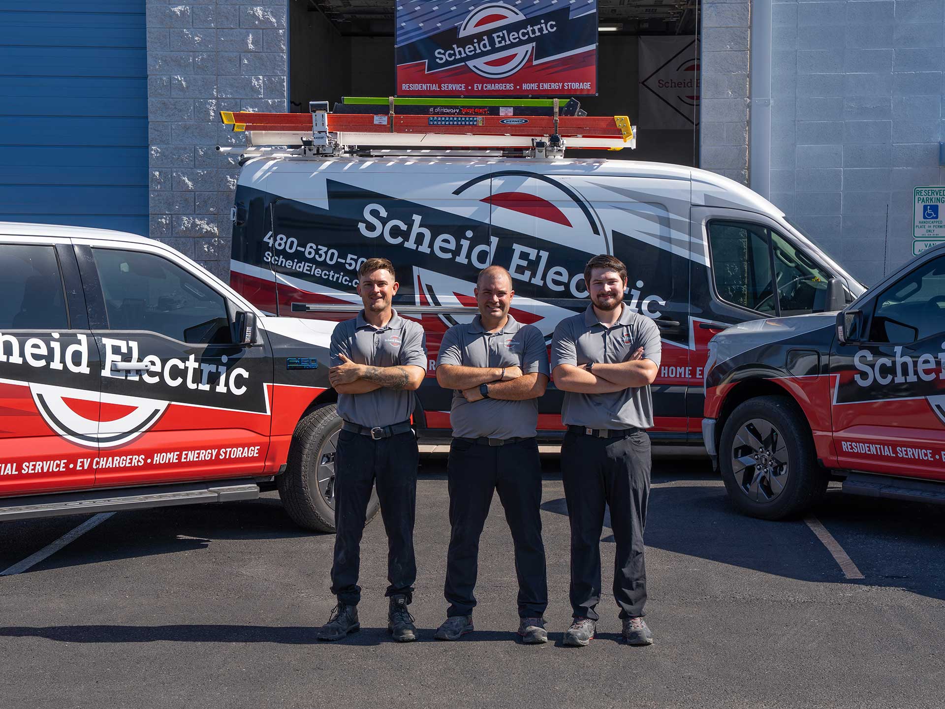 Schied Electric Three Electricians In Front Trucks